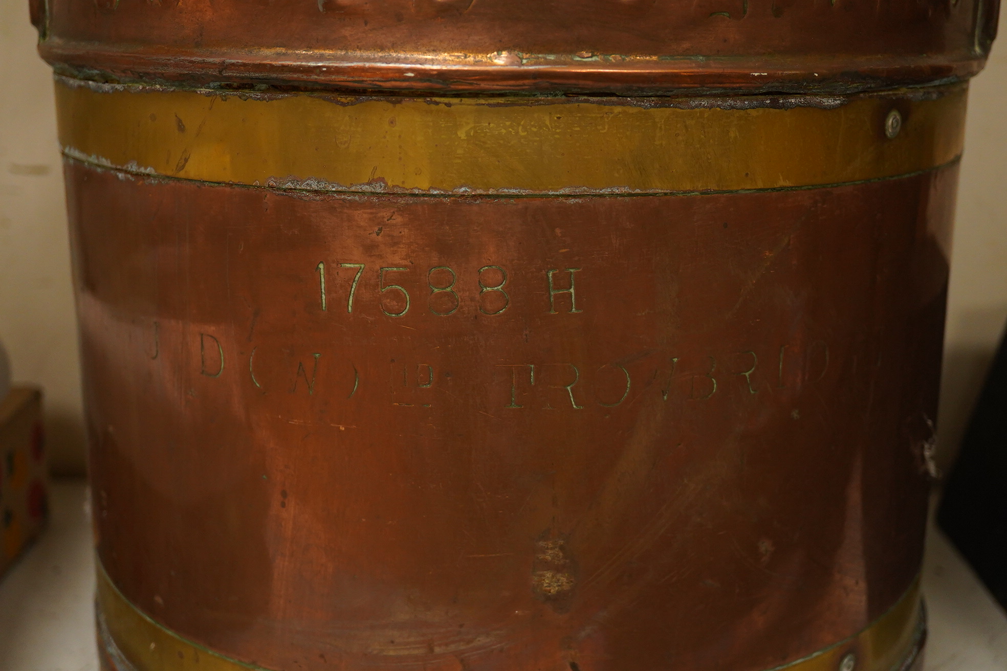 A United Dairies copper and brass banded milk churn, 52cm high. Condition - fair to good